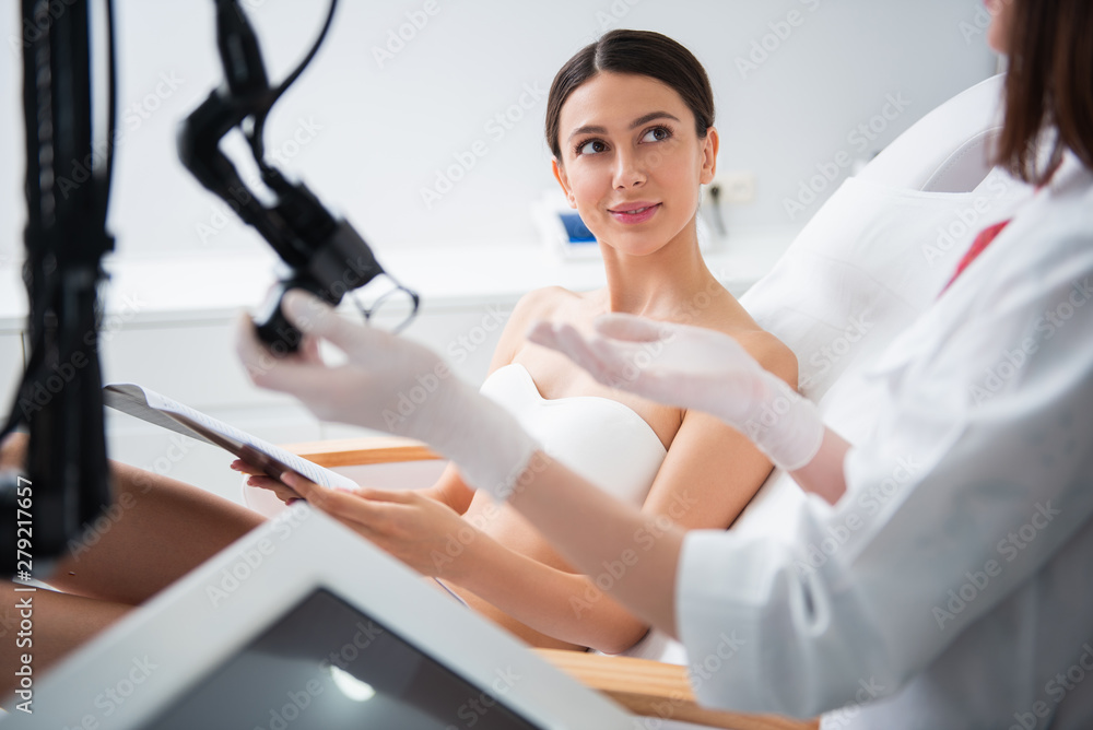 Specialist explain how is working laser device Specialist explain how is working laser device