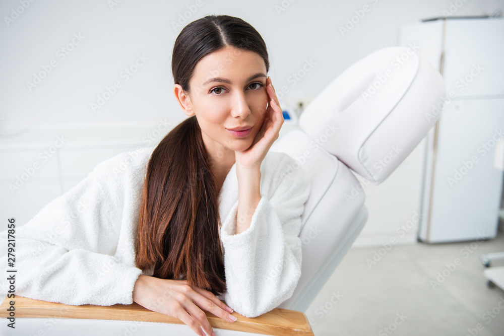 Relaxed smiling lady on couch in spa center Relaxed smiling lady on couch in spa center