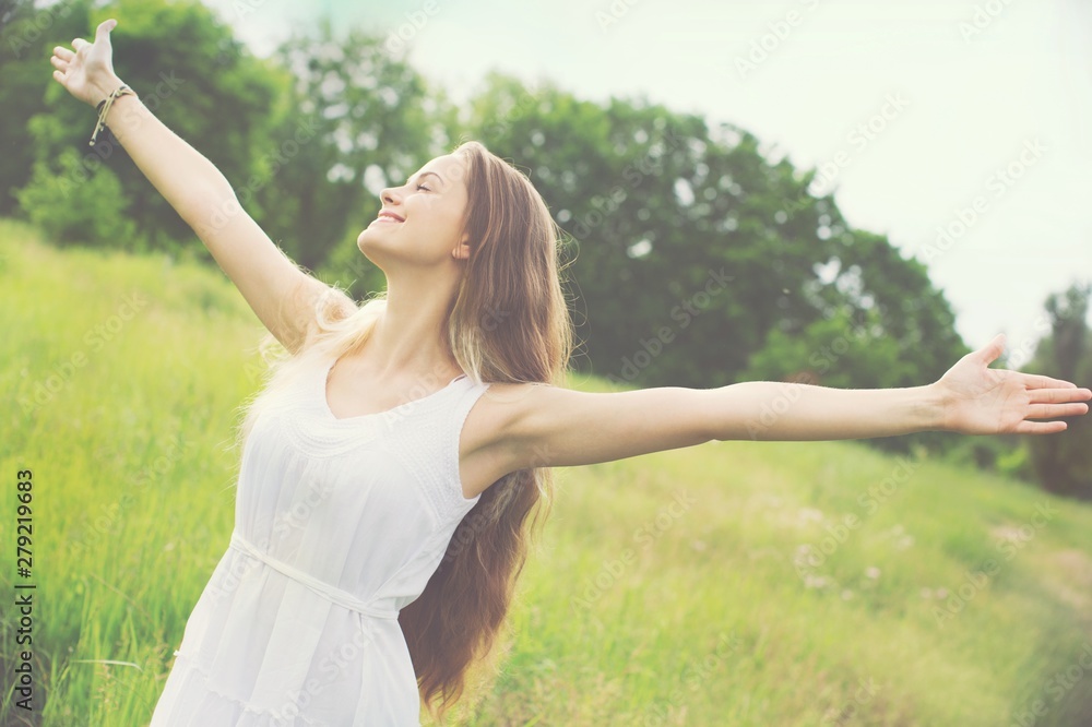 Young woman on field under sunset light Young woman on field under sunset light