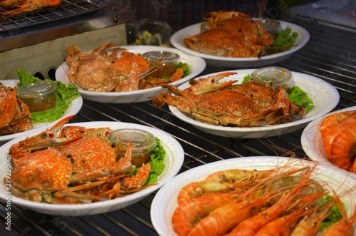 Crabs with salad and sauce in plates 