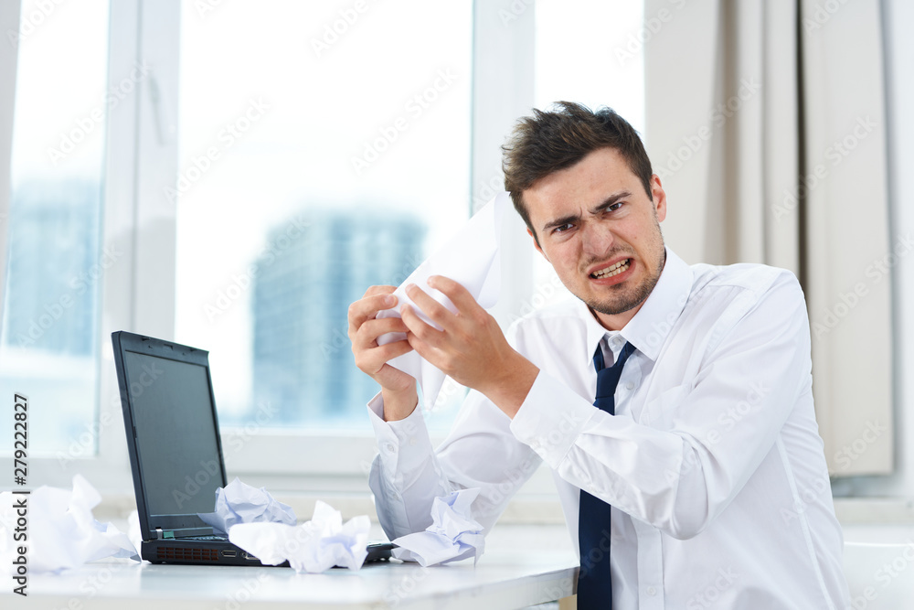 businessman working on his laptop in an office businessman working on his laptop in an office