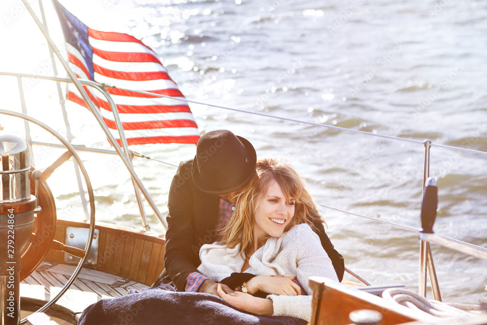 Obraz premium Young couple relaxing on yacht