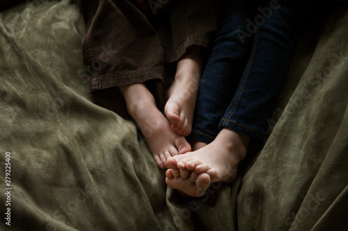 Childrens' (4-5) legs on bean bag,  close-up