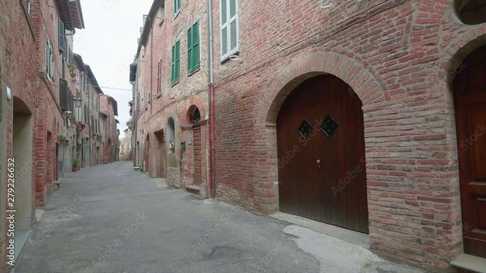 Perugia 2019. Empty road on a spring morning in Città Della Pieve. The walls are in the typical red brick of Umbria. April 2019 in Perugia Perugia 2019. Empty road on a spring morning in Città Della Pieve. The walls are in the typical red brick of Umbria. April 2019 in Perugia