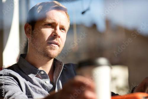 Fotografija Man daydreaming in cafe