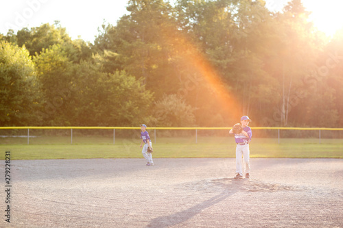Photography Little league players (8-9) moving to positions on field
