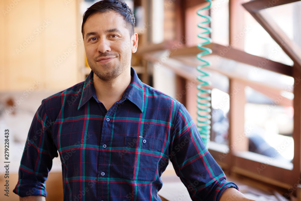 Fototapeta premium Carpenter posing in workshop