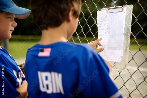 Fotografie Baseball players looking at lineup list
