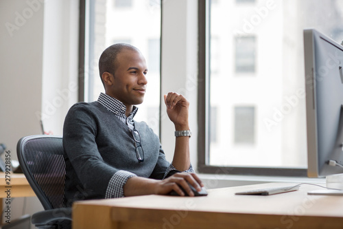 Fotografija Young man working on computer in office