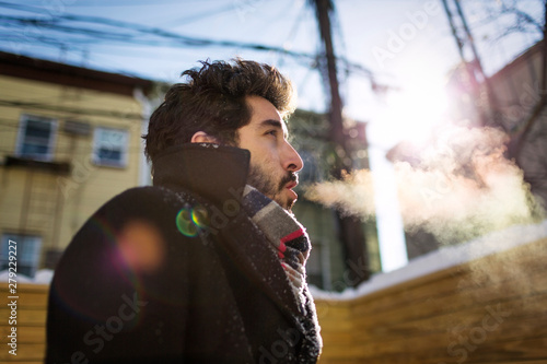 Fotografie Man breathing out during winter