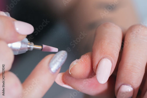Treatment of the nail on the hand with a special apparatus with a cutter for manicure