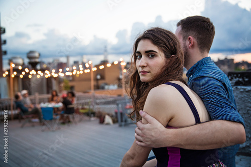 Fotografija Young man embracing his girlfriend on rooftop