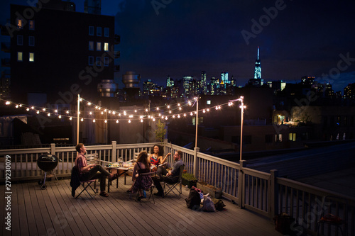 Photography Group of friends sitting on roof terrace