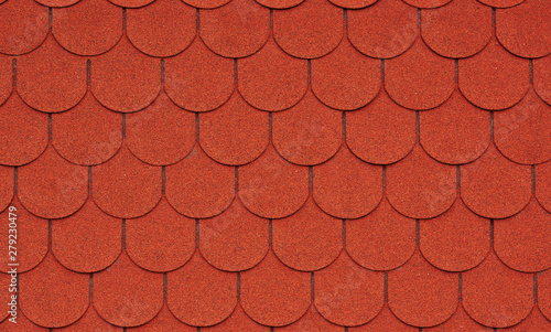 Close up view on red asphalt roofing shingles background.