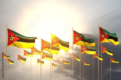 cute holiday flag 3d illustration. - many Mozambique flags in a row on sunset with free place for content