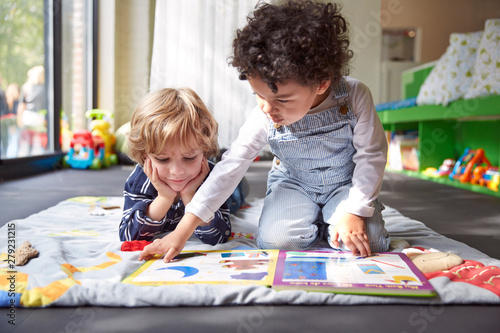 Friends reading book at home