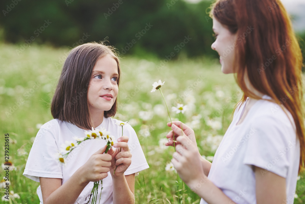 mother and daughter blowing soap bubbles in the park mother and daughter blowing soap bubbles in the park