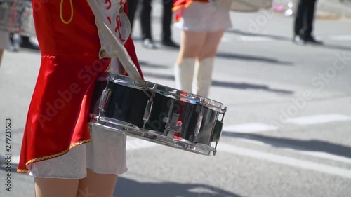 Close-up of female hands drummers are knocking in the drum of their sticks. Street performance on the occasion of the holiday