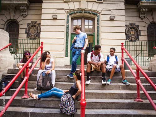 Photography Teenage friends sitting on steps outdoors