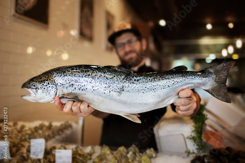 Canvas Print Portrait of fish vendor indoors