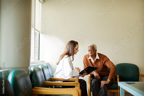 Принти на полотні Doctor talking with patient in waiting room