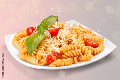 A baked dish of fusilli or pasta spirals, with cherry tomatoes, ricotta and parmesan