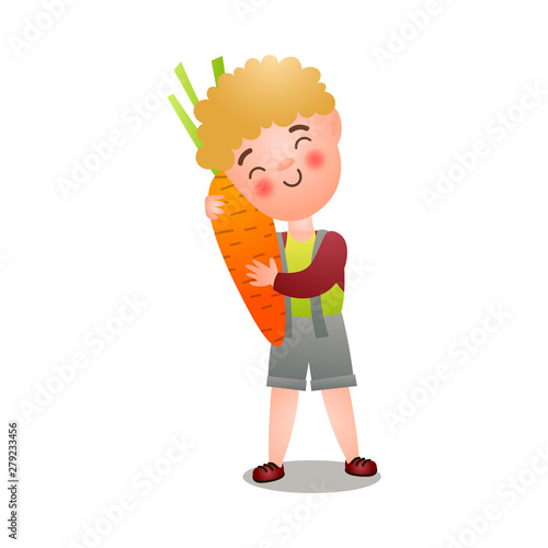 Cute blonde happy boy is ready for eat fresh carrot