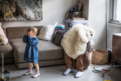 Father and daughter playing hide and seek at home