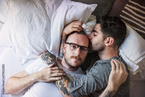Cuadro en lienzo Couple relaxing on bed at home