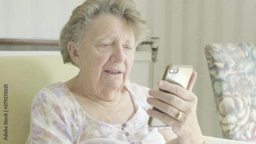 Senior caucasian woman using a smartphone themes of retired pensioner technology wifi Senior caucasian woman using a smartphone themes of retired pensioner technology wifi