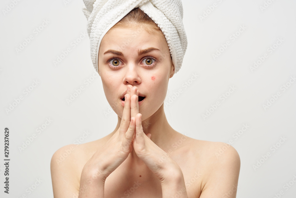 young woman applying moisturizer cream on her face young woman applying moisturizer cream on her face