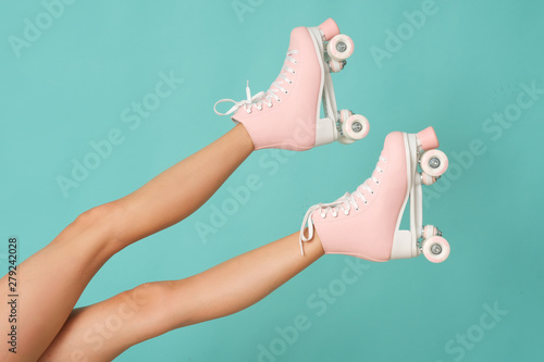 Pink roller skates on the legs. Activity can be fun!