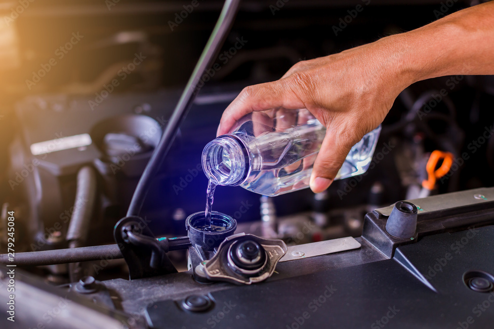 hands of mechanic check water in car radiator and add water to car radiator,  service and maintenance of cars or vehicles, selective focus. Stock Photo |  Adobe Stock