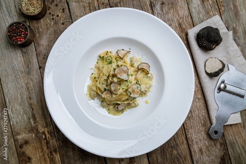 pasta with porcini mushrooms and truffle on old wood background photo