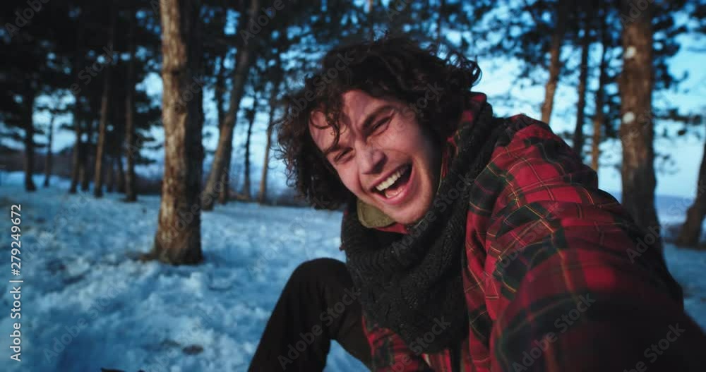 Good looking tourist man on the snowy forest capturing his self in front of the camera make a video very enthusiastic he enjoying the time while traveling alone Good looking tourist man on the snowy forest capturing his self in front of the camera make a video very enthusiastic he enjoying the time while traveling alone