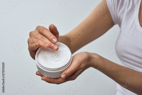 hands holding a cup of tea isolated on white