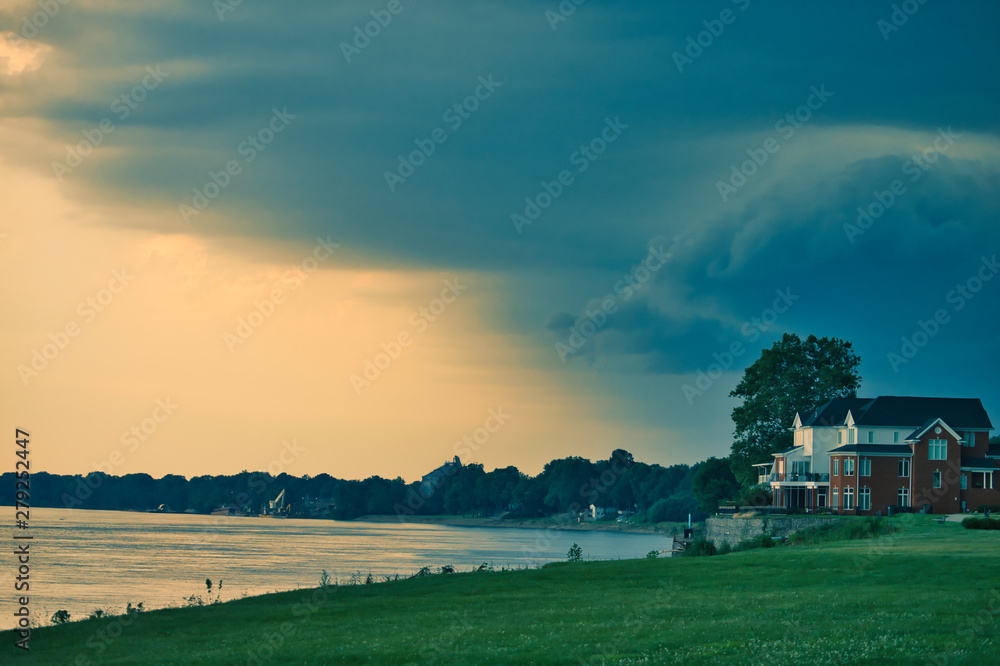 storm approaching riverbank at dusk - mid crop storm approaching riverbank at dusk - mid crop