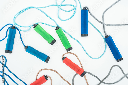 blue red and green skipping ropes isolated on white