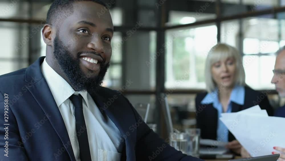 Afro-american businessman rejoicing good news on tablet PC, successful deal Afro-american businessman rejoicing good news on tablet PC, successful deal