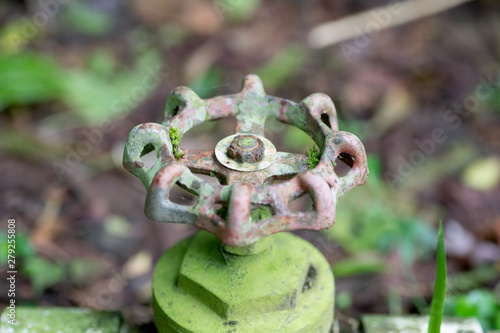 Close up of an old water valve rusting away