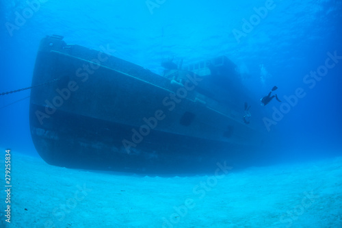 A diver explores the USS Kittiwake, one of the best-known wreck dives in the Caribbean Sea. The 251-foot long ship was sunk off the coast of Grand Cayman in 2011 in order to create an artificial reef. © ead72
