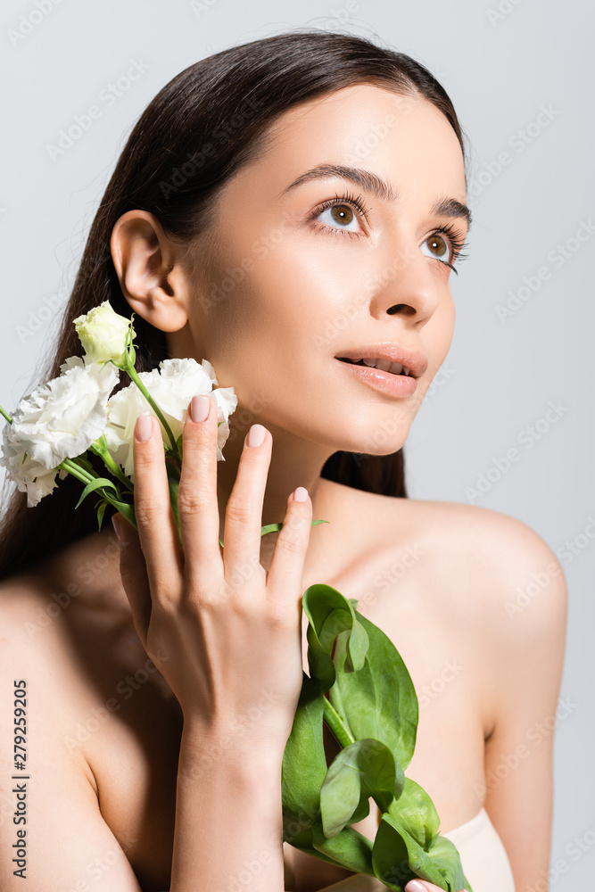 beautiful woman with white carnations looking away isolated on grey beautiful woman with white carnations looking away isolated on grey