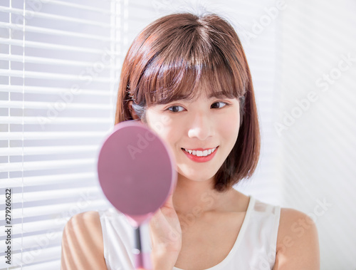 Young asian woman look mirror