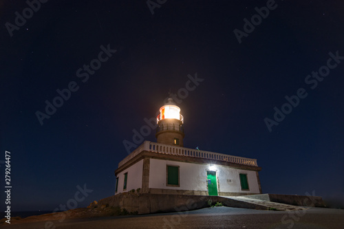Night photography with full moon in Corrubedo lighthouse Galicia Spain