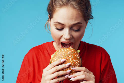 young girl eating a sandwich