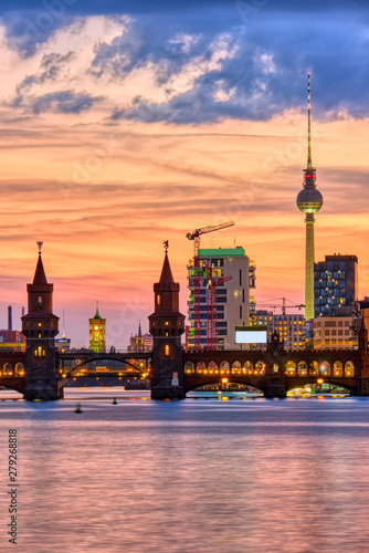 Beautiful sunset at the Oberbaum Bridge in Berlin with the famous Television Tower in the back