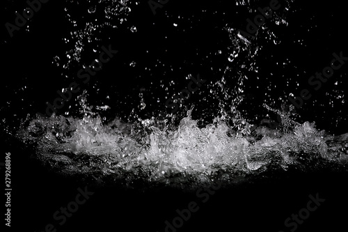 Movement of the Water splash on black background. Water drop from the fountain. Can use for add text and abstract background.