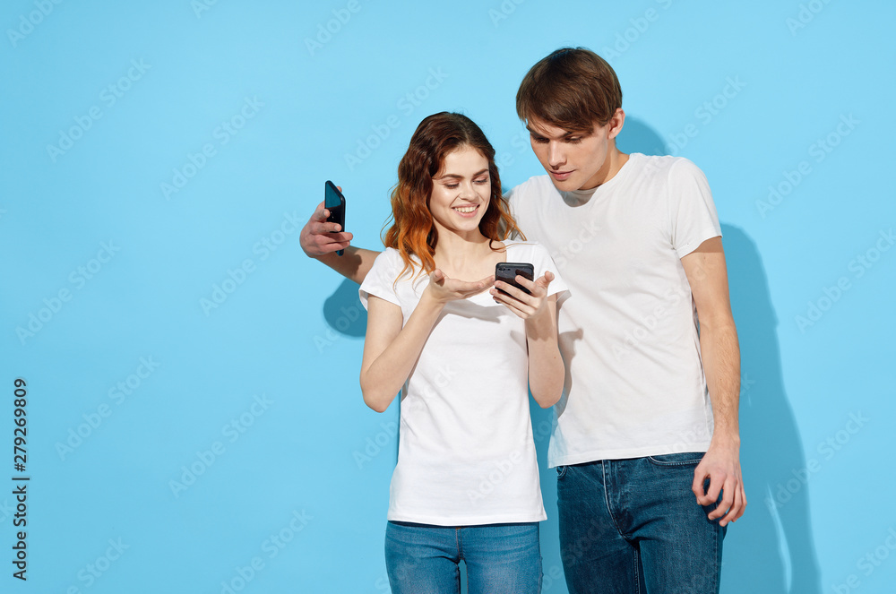 young couple taking picture of themselves with mobile phone