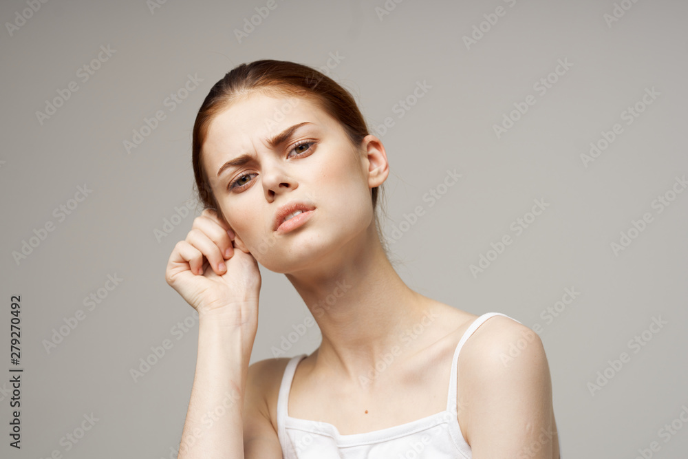 young woman applying cream on her face young woman applying cream on her face