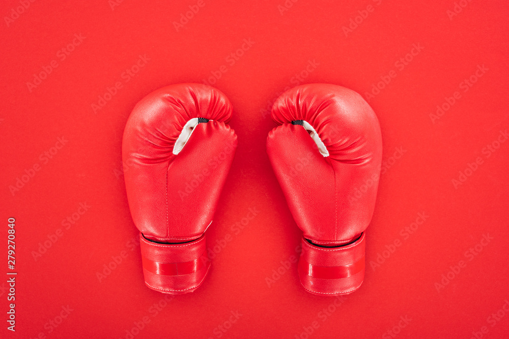 top view of pair of leather boxing gloves isolated on red